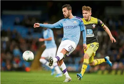  ?? — Reuters ?? He’s too quick: Manchester City’s Bernardo Silva (left) in action against Southampto­n’s Jake Vokins during the English League Cup fourth-round match at the Etihad on Tuesday.