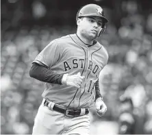  ?? Abbie Parr / Getty Images ?? Aledmys Diaz, who started as the Astros’ DH for the first time, rounds the bases after hitting a decisive homer in the seventh.