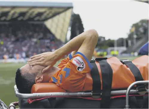  ??  ?? 0 Agony for Jamie Murphy as he is carried off at Rugby Park on a stretcher. His team-mate James Tavernier blamed the artificial pitch.