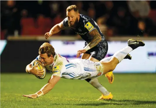  ?? PICTURES: Getty Images ?? Winging in: Exeter’s Lachie Turner scores past Byron McGuigan