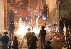  ?? REUTERS ?? Palestinia­ns react as Israeli forces fire a stun grenade during clashes in Al-quds’ Old City on May 9, 2021.