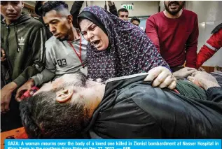  ?? — AFP ?? GAZA: A Woman mourns over the body of a loved one killed in to Zionist bombarment at Nasser Hospital In Khan Yunis in the southern Gaza Strip on Dec 27, 2023.