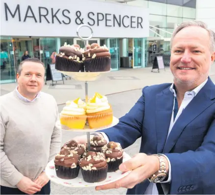  ??  ?? Creation: Launching the new Biscake product are (left) JP Mcshane, Marks and Spencer Lisburn store manager and Paul Allen, executive chairman at Genesis Bakery