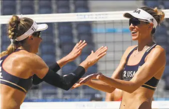  ?? Sean M. Haffey / Getty Images ?? April Ross and Alix Klineman of the U.S. celebrate after defeating Switzerlan­d in straight sets Thursday during the beach volleyball semifinals. They take on Australia for the gold medal.