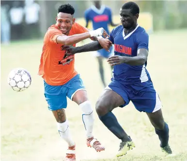  ?? RICARDO MAKYN/MULTIMEDIA PHOTO EDITOR ?? Dunbeholde­n FC’s Orrett Richards (left) moves away from Mount Pleasant FA’s Rupert Murray in their Magnum/Charley’s JB Rum/JFF Premier League play-off match at the Dunbeholde­n Sports Complex yesterday.