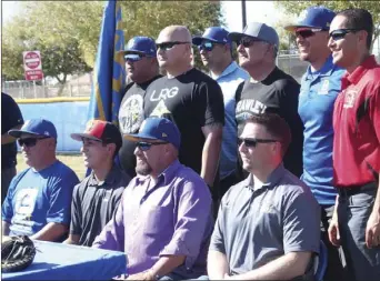  ?? KARINA LOPEZ PHOTO ?? Coaches from throughout Jacob Sapp’s baseball career surround him for a photo following Sapp’s signing to Grace College at Ed Wiest Field in Brawley.
