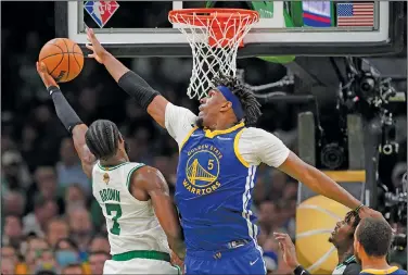  ?? Associated Press ?? At the rim: Boston Celtics guard Jaylen Brown (7) puts up a shot against Golden State Warriors center Kevon Looney (5) during the fourth quarter of Game 6 of basketball's NBA Finals earlier this month in Boston.