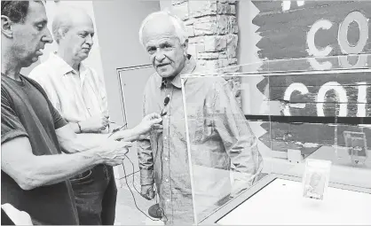  ?? DAVID ZALUBOWSKI THE ASSOCIATED PRESS ?? Marshall Fogell, right, stands next to the display case containing one of the rarest baseball cards circulatin­g, a 1952 Topps Mickey Mantle, that he owns and is being put out for public viewing to promote a baseball memorabili­a exhibit opening at the Colorado History Museum.