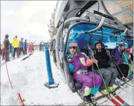  ?? Brett Miller ?? The Associated Press Skiers ride a chairlift Saturday at the Mount Snow ski resort in West Dover, Vt. Early season snow and cold temperatur­es are helping New England ski resorts get the 2018-2019 season off to a blizzard of a start.