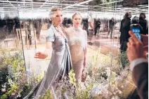  ?? FRANCOIS MORI/AP ?? Model Kate Moss, left, and her daughter Lila Grace Moss wear creations for Fendi’s Spring-Summer 2021 Haute Couture fashion collection Jan. 27 presented in Paris. The pandemic has stopped runway shows and forced brands to show their designs digitally instead.