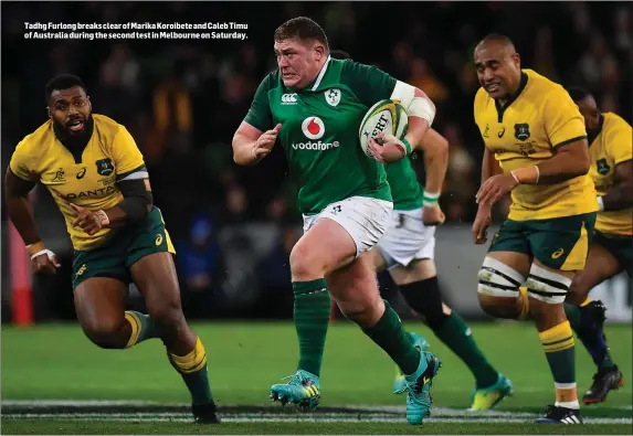  ??  ?? Tadhg Furlong breaks clear of Marika Koroibete and Caleb Timu of Australia during the second test in Melbourne on Saturday.