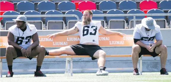  ?? WAYNE CUDDINGTON ?? Jon Gott, centre, says he wants to be on the field. “I’ll keep on showing up to work, keep on doing what I’m doing, and hopefully I get back out there soon.”