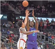  ?? USA TODAY SPORTS ?? Hornets forward Marvin Williams (2) shoots over Hawks forward John Collins (20).