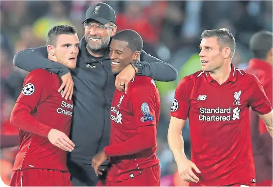  ??  ?? Liverpool manager Jurgen Klopp is a happy man, surrounded by Andrew Robertson, Georginio Wijnaldam and James Milner