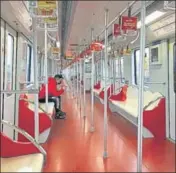  ?? AP ?? A child (left) bounces on an amusement ride at Beijing’s Longtan Park; a man (right) rides a nearly empty subway train in Shanghai.