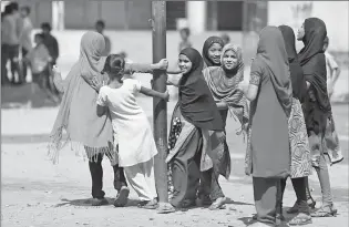  ??  ?? Schoolgirl­s play Tuesday at a government school in Hyderabad, India. Indian women still face some of the world’s worst inequality in access to health care, education and work, despite years of rapid economic growth, according to the annual Gender Gap...