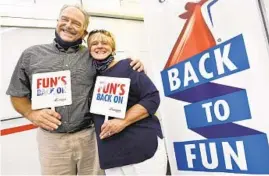  ?? AMY DAVIS/BALTIMORE SUN ?? Robert and Nancy Houchens, of North Garden, Virginia, who have been on more than 200 cruises together, were selected to cut the ceremonial ribbon marking the return of Carnival Pride to Baltimore.