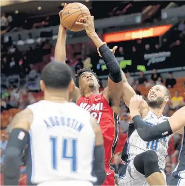  ?? MIKE STOCKER/SUN SENTINEL ?? Heat center Hassan Whiteside tries to get off a shot while being closely guarded by the Magic’s Evan Fournier on Tuesday.