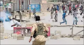  ?? AP PHOTO ?? Protesters and policemen clash after Hizbul militant Burhan Wani was killed, in Srinagar on Saturday.