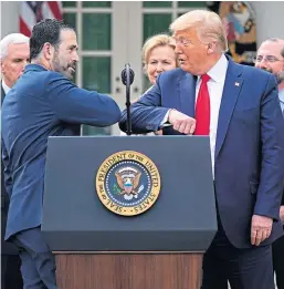  ??  ?? Bruce Greenstein, of the health care company LHC Group, elbow bumps with President Trump during a news conference about coronaviru­s. Picture: AP.