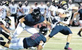  ??  ?? Westmoore’s Doug Collins pulls down Broken Arrow’s Noah Cortes during Friday’s high school football game between Westmoore and Broken Arrow in Moore. Broken Arrow won 41-7.