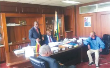  ??  ?? ZANU-PF national commissar Saviour Kasukuwere (seated behind desk) and Temba Mliswa (standing) discuss the later’s victory in the Norton by-election where he contested as an independen­t candidate after he was expelled from the ruling party