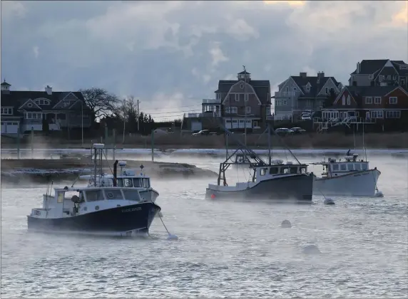  ?? STUART CAHILL — BOSTON HERALD ?? Ice and Sea Smoke, which occurs when frigid temperatur­es meet the much warmer sea water, adds a mosaic look to the coastline on Saturday Scituate.