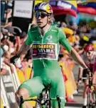  ?? Thibault Camus / Associated Press ?? Belgium’s Wout Van Aert, wearing the best sprinter’s green jersey, celebrates as he crosses the finish line in Lausanne, Switzerlan­d.