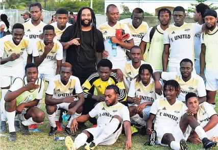  ??  ?? Reggae star Ky-Mani Marley (centre) with the Falmouth United team.