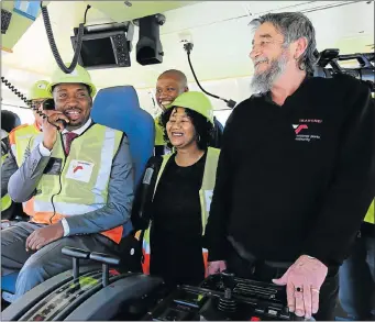  ?? Pictures: WERNER HILLS ?? WELCOME ABOARD: Deputy Minister in the Presidency for Planning Monitoring and Evaluation Buti Manamela enjoys being in the hot seat on the Mvezo, one of two new super-tugs at the PE harbour. Port of Ngqura manager Tandi Lebakeng, centre, and the master...