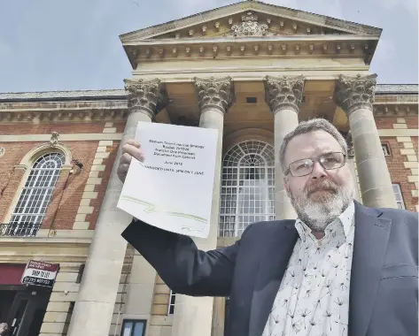  ??  ?? Cabinet member for resources Cllr David Seaton with a copy of a previous budget