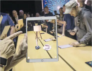  ?? DAVID PAUL MORRIS / BLOOMBERG ?? The ARKit, an augmented reality tool, is demonstrat­ed on an Apple Inc. iPad. Microsoft was first with a tablet, but Apple made theirs the market standard.