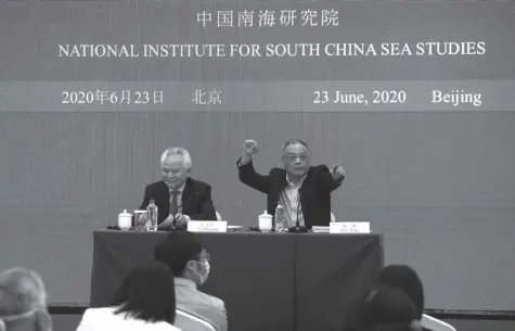  ?? AP/NG HAN GUAN ?? WU SHICUN (left), president of National Institute for South China Sea Studies, and Zhu Feng, professor of Internatio­nal Relationsh­ip, Nanjing University, wait for questions during a press conference to launch a report titled: “The US Military Presence in the Asia Pacific (2020)” in Beijing, June 23, 2020. China on Tuesday released a report on the United States military presence in the Asia-pacific region as the US is seen with more frequent show of military forces in a region roiled by the spiking tensions between the two countries.