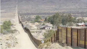  ??  ?? Houses are seen on the Mexican side of the Us-mexico border fence in Jacumba, California. — AFP