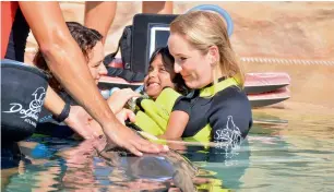  ?? Supplied photos ?? Meznah Basaloum during her therapy at Amana Healthcare and (right) her enjoying the waters at the Atlantis. —