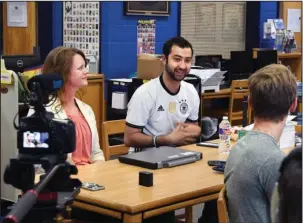 ?? The Sentinel-Record/Grace Brown ?? INSTILLING HOPE: Mouaz Moustafa, center, speaks during an interview Thursday with the Lakeside Broadcasti­ng Class prior to giving a presentati­on to fifth and seventh graders at Lakeside Middle School about the Syria Emergency Task Force.