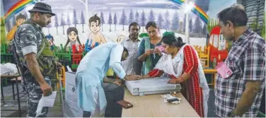  ?? Agence France-presse ?? ↑ Polling officials seal an EVM at a booth in Masuri village of Ghaziabad district in Uttar Pradesh on Friday.