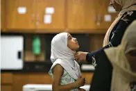  ??  ?? below, near left This photo shows the new Victoria Islamic Center still under constructi­on July 20 in Victoria, Texas. In designing the new mosque, leaders added cameras, alarms, lighting and strategic landscapin­g, such as cutting down hedges where...