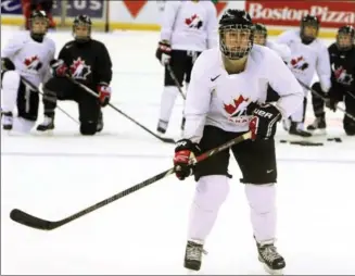  ?? FRED CHARTRAND, THE CANADIAN PRESS ?? Canada’s Hayley Wickenheis­er takes part in a drill at practice on Sunday as teammates look on at the Ice world women’s hockey championsh­ip in Ottawa. A back injury forced her to sit out several earlier games.