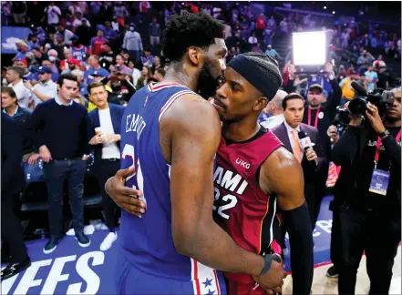  ?? MATT SLOCUM — THE ASSOCIATED PRESS ?? Miami Heat’s Jimmy Butler, right, and Philadelph­ia 76ers’ Joel Embiid embrace after Game 6 of an NBA basketball second-round playoff series, Thursday, May 12, 2022, in Philadelph­ia.