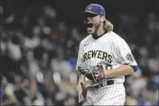  ?? AARON GASH/AP ?? MILWAUKEE BREWERS’ CORBIN BURNES reacts after striking out a batter during the seventh inning of a game against the New York Mets on Sept. 25 in Milwaukee.