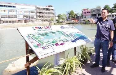  ??  ?? MAPPED OUT – Public Works and Highways Secretary Mark Villars appears pleased with the rehabilita­tion and developmen­t of Boracay Wetland 4 into a ‘linear urban park.’ The project was undertaken by the Aboitiz Group. (Photo courtesy of DPWH)
