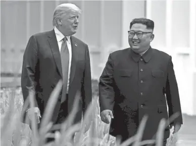  ?? EVAN VUCCI/AP FILE ?? President Donald Trump and North Korean leader Kim Jong Un talk in Singapore in 2018. In his time in office, Trump drew mixed reactions for cozying up to authoritar­ian leaders like Kim and Russia’s Vladimir Putin.