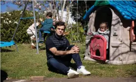  ?? Photograph: Carly Earl/The Guardian ?? Sydney father Misha with his daughter at their Roseville home. He is angry at health authoritie­s for placing his family in accommodat­ion surrounded by active Covid cases.