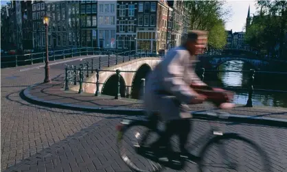  ?? Photograph: Alamy Stock Photo ?? Cycling in Amsterdam. The national rebranding of the Netherland­s will be rolled out later this year.