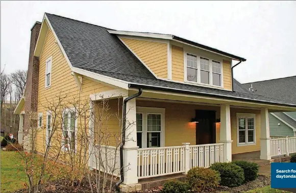  ?? CONTRIBUTE­D PHOTOS BY KATHY TYLER ?? Craftsman styling features of this recent Oakwood home include a wide front porch with a decorative railing, wide-based square columns and a bead-board ceiling. Ornamental grasses, evergreens, trim boxwoods and other bushes are part of the profession­al...