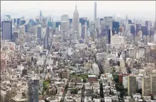  ?? Associated Press ?? The Empire State Building, as seen from the observator­y at One World Trade Center in New York, is one of many destinatio­ns that are off-limits in the return to old-fashioned summer.