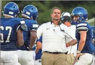  ?? / Steven Eckhoff ?? Model head football coach Ricky Ross talks to players in between plays during a preseason scrimmage against Mt. Zion-Carroll on Friday at Model.