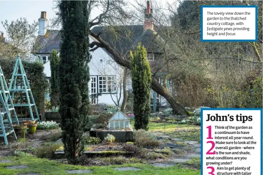  ??  ?? The lovely view down the garden to the thatched country co age, with fastigiate yews providing height and focus