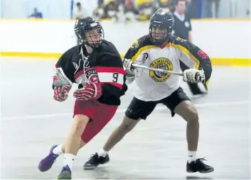  ?? JULIE JOCSAK/STANDARD STAFF ?? Kielon Pilon, left, of the St. Catharines Spartans tries to get the ball around Jordan Acke of Hamilton in junior B lacrosse exhibition action in St. Catharines earlier this month. The Spartans host Owen Sound in the season opener Saturday at Merritton...